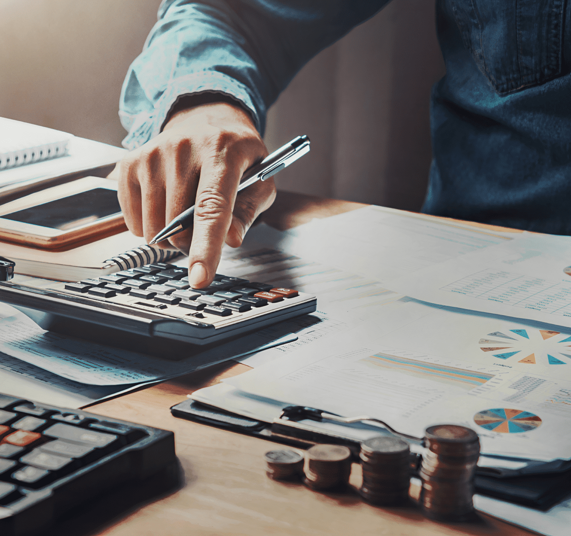 Person using calculator on financial documents.
