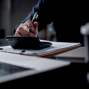 Person using calculator and writing notes